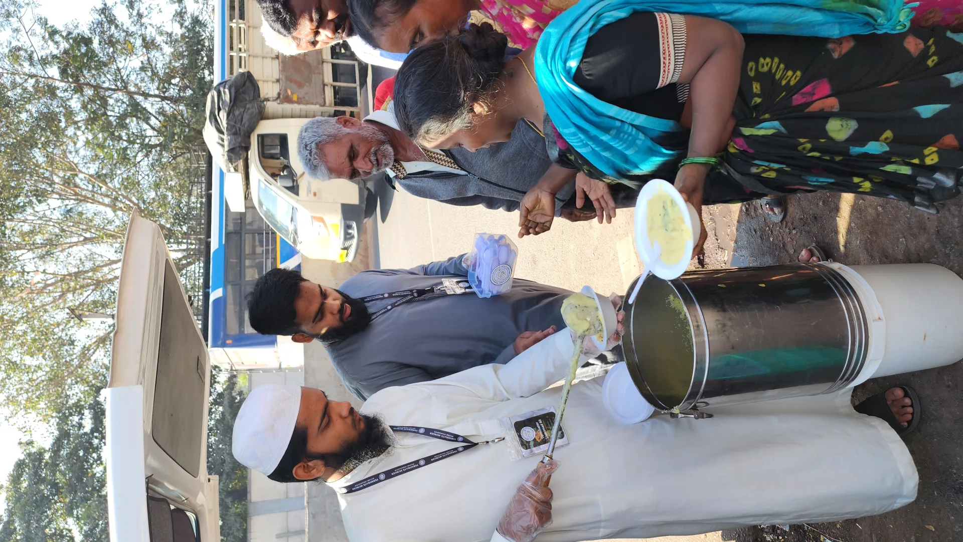 Volunteers distributing cooked food to the community